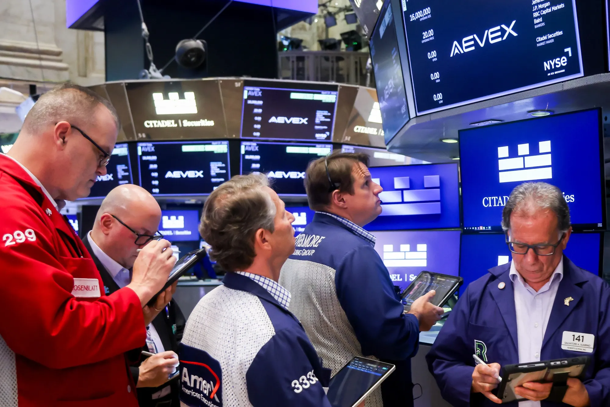 Traders work during the Aevex Corp. IPO on the floor of the New York Stock Exchange on April 17.