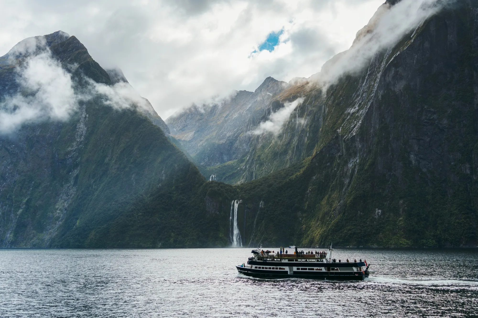 A ferry carrying tourists at Milford Sound, New Zealand.