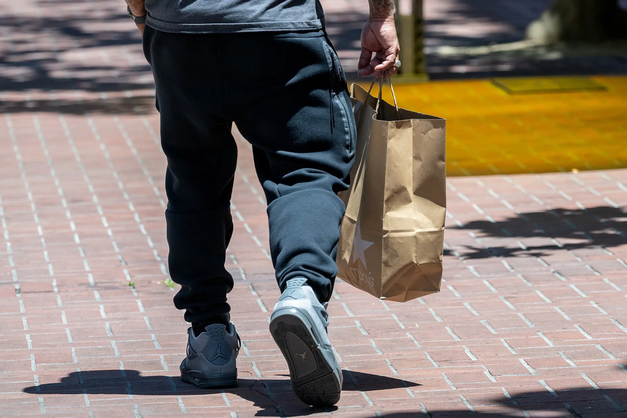 A shopper carries a Macy's shopping bag in San Francisco, California, US.