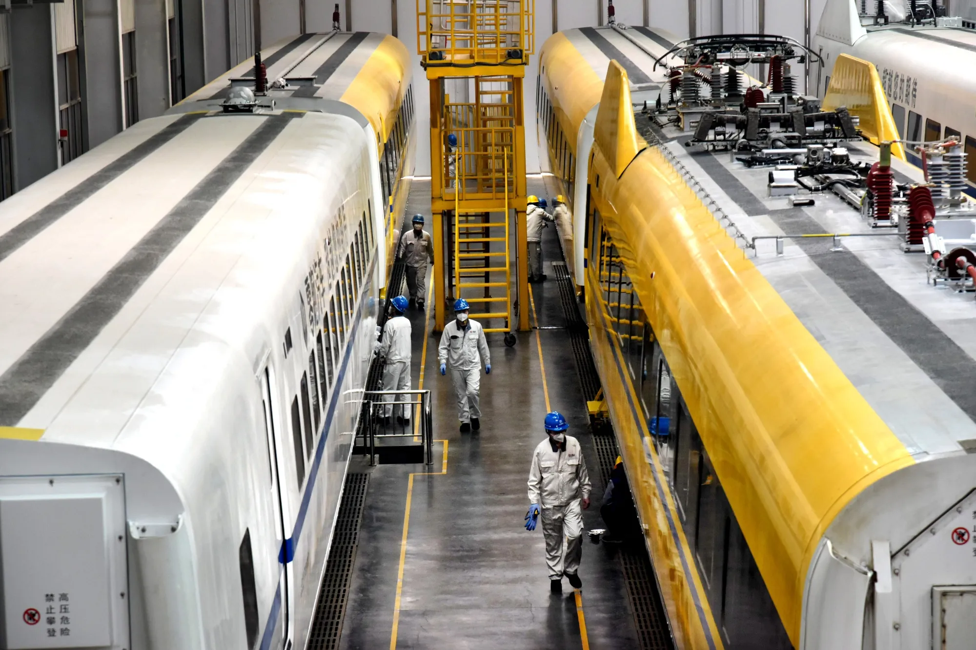 Technicians debug trains at a workshop of CRRC Qingdao Sifang Co., Ltd. in Qingdao, east China's Shandong Province.