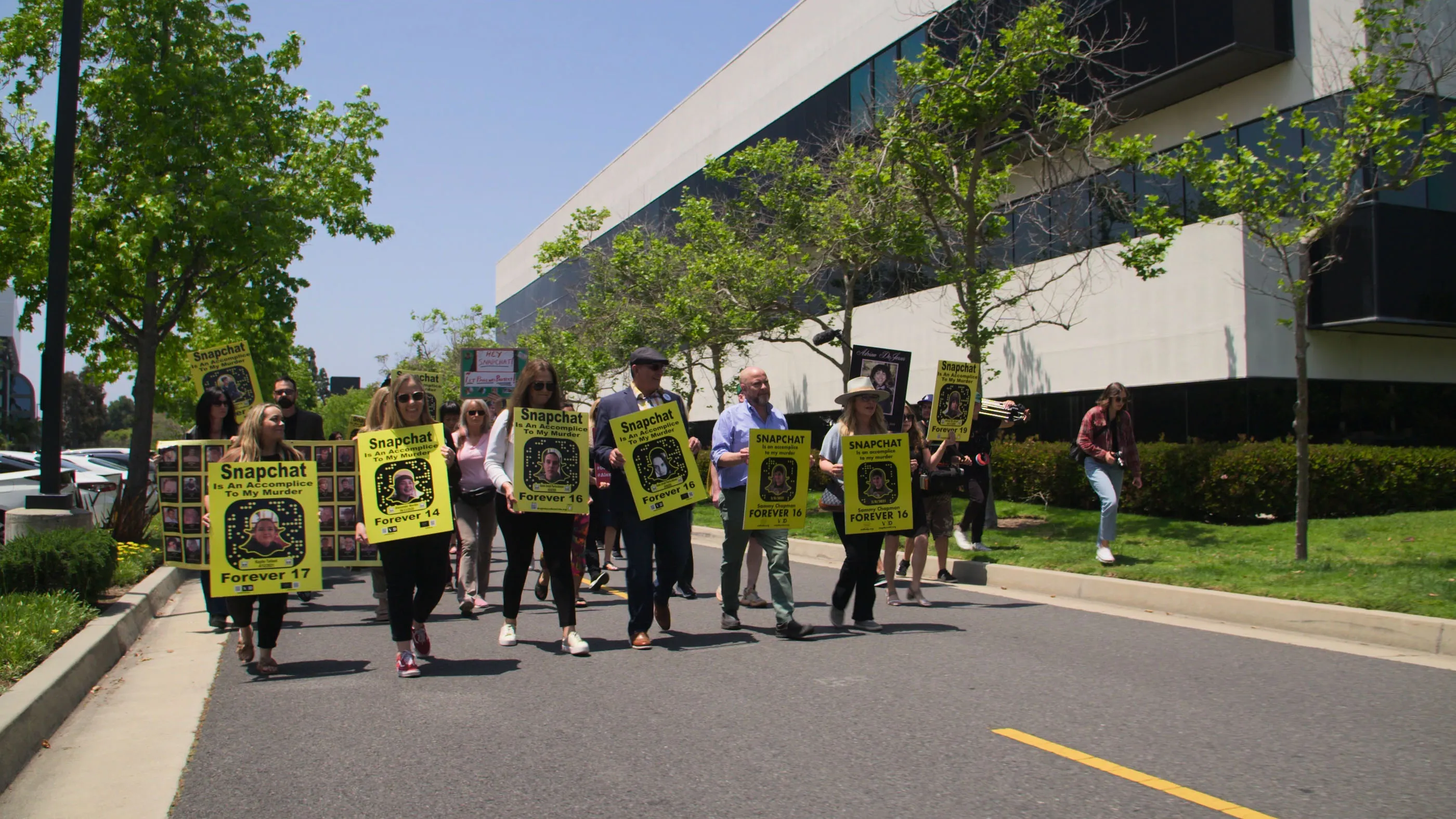 Demonstrators, including parents, march in May 2023 outside Snap headquarters in Santa Monica, California.