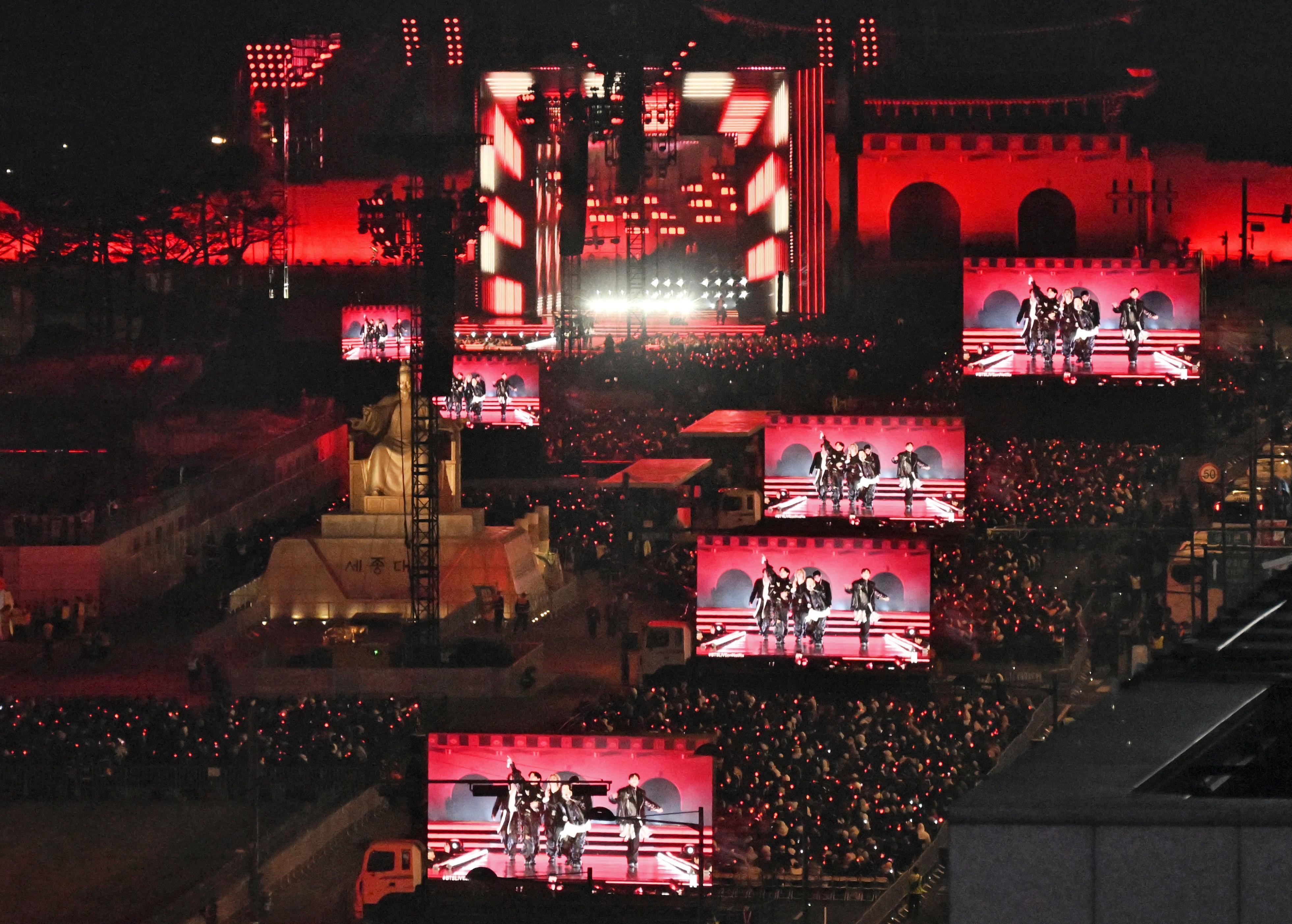 BTS perform onstage during their comeback concert at Gwanghwamun Square in Seoul on March 21. Source: Kyodo News/Getty Images