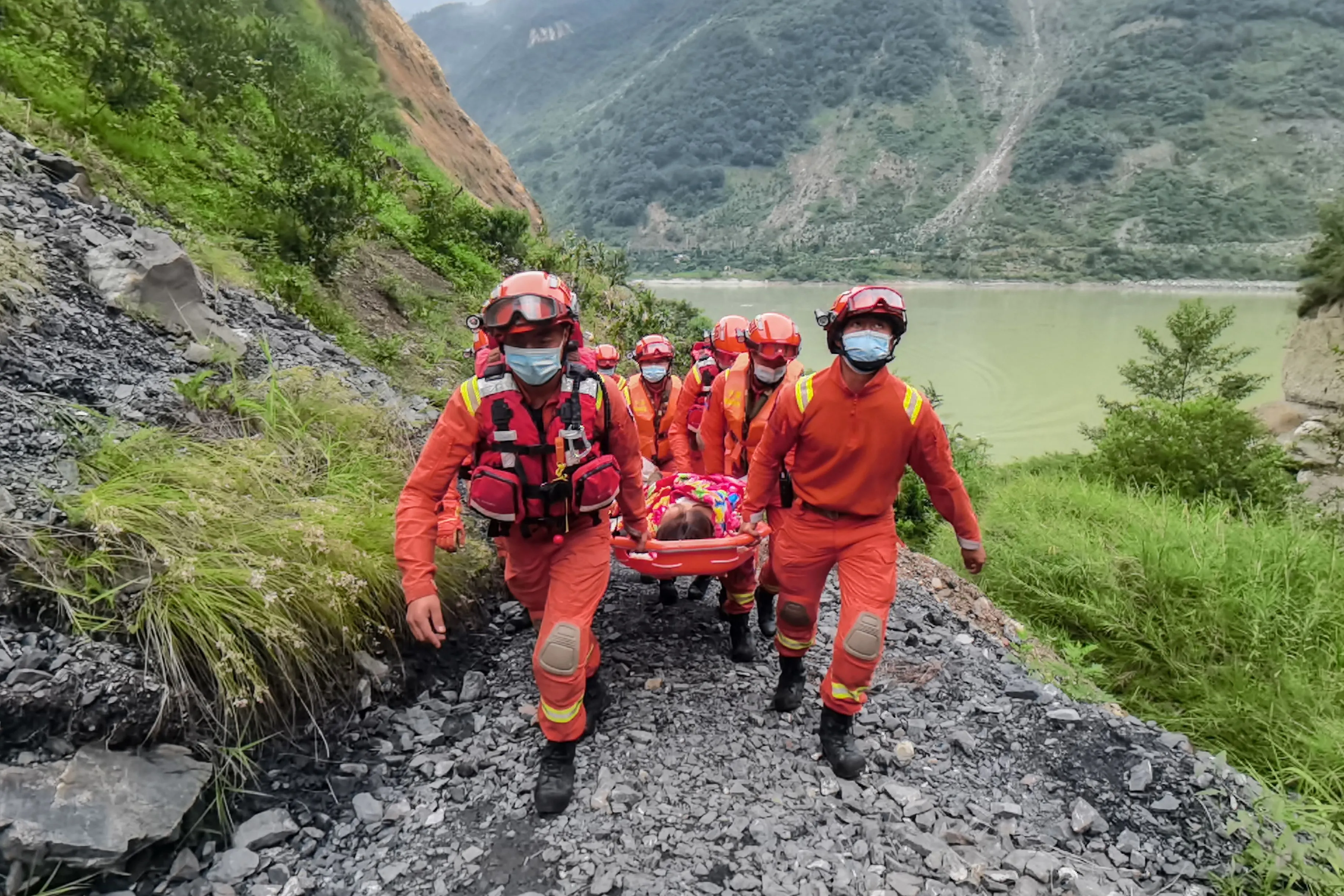 Rescue workers carry an injured person following an earthquake in Sichuan province on Sept. 6.