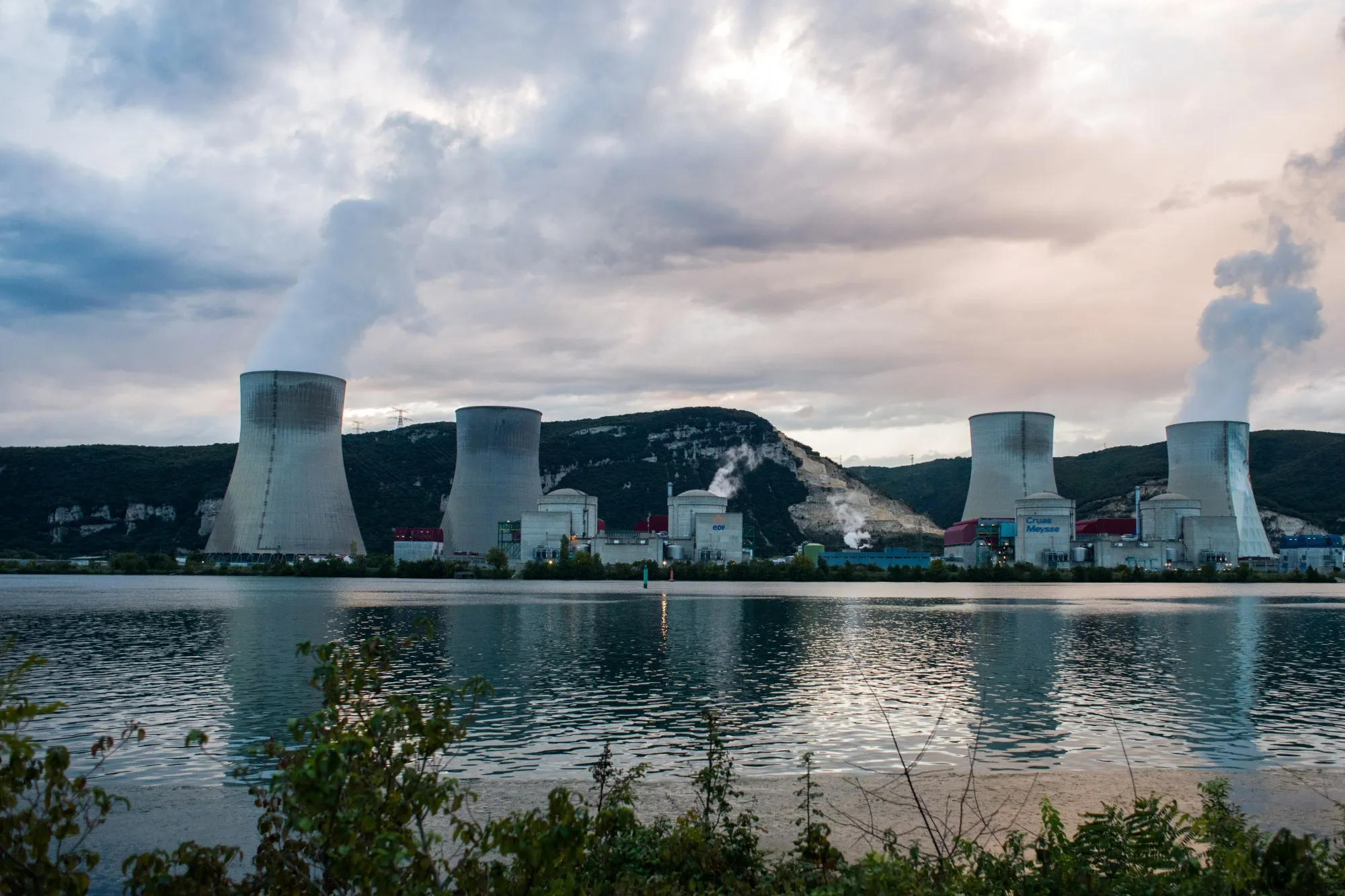 Vapor rises from cooling towers next to reactor buildings in the Cruas Nuclear Power Plant on the River Rhone in Cruas, France.