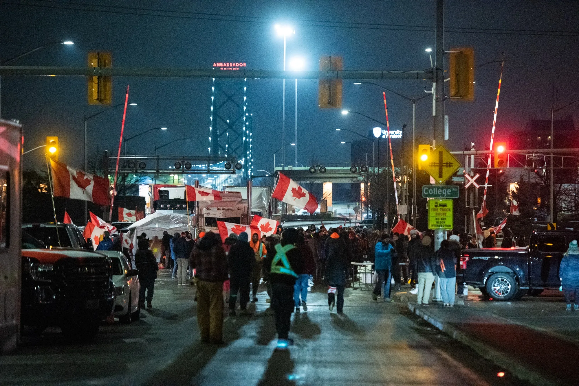 Protesters wave Canadian flags while blocking access to the Ambassador Bridge during a demonstration in Windsor, Ontario, Canada.