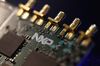 Microprocessors sit on a circuit board displayed on the NXP Semiconductors NV pavilion at the Mobile World Congress in Barcelona, Spain, on Monday, March 2, 2015.