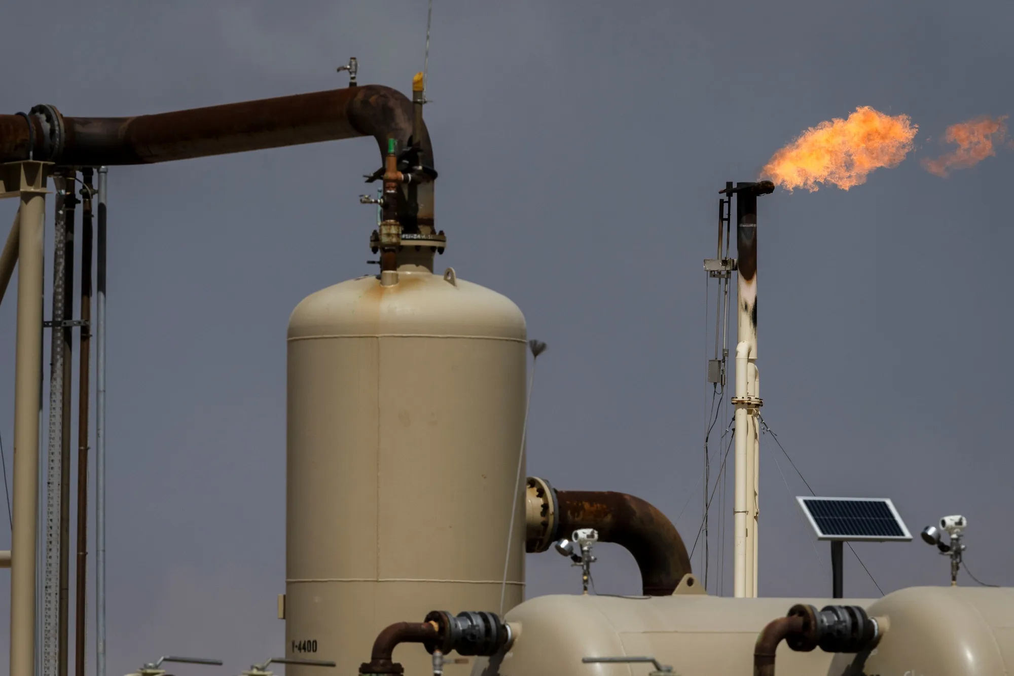 Flares burn off excess natural gas at the Endeavor Energy Resources LP oil and gas wells near Tarzan, Texas, on March 15, 2025. 