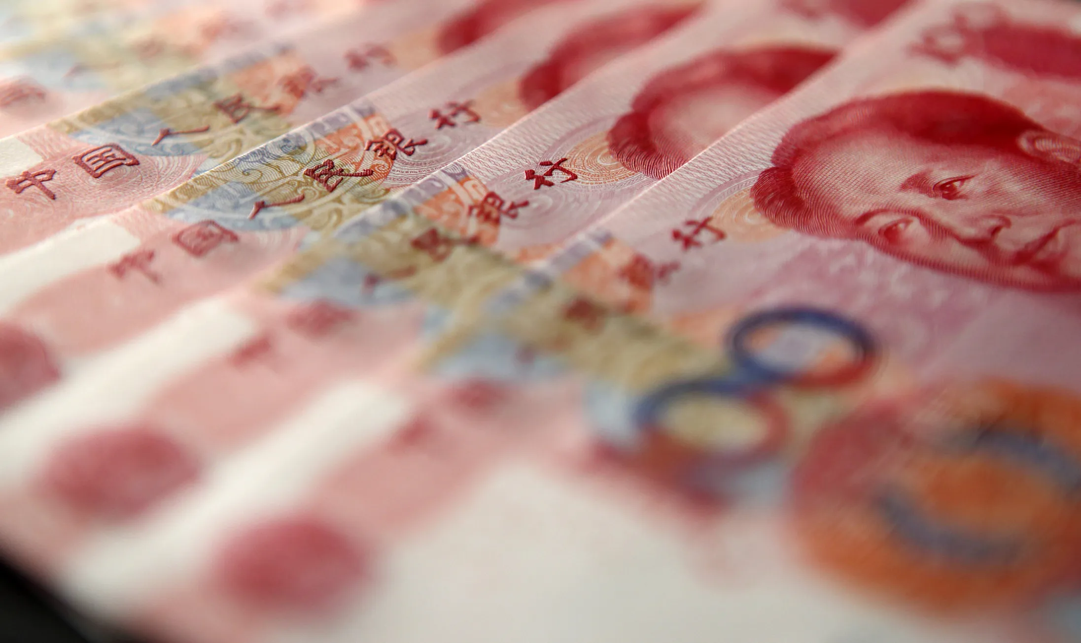 Chinese one-hundred yuan banknotes are arranged for a photograph in Tokyo, Japan, on Tuesday, Aug. 11, 2015. China devalued the yuan by the most in two decades, a move that rippled through global markets.
