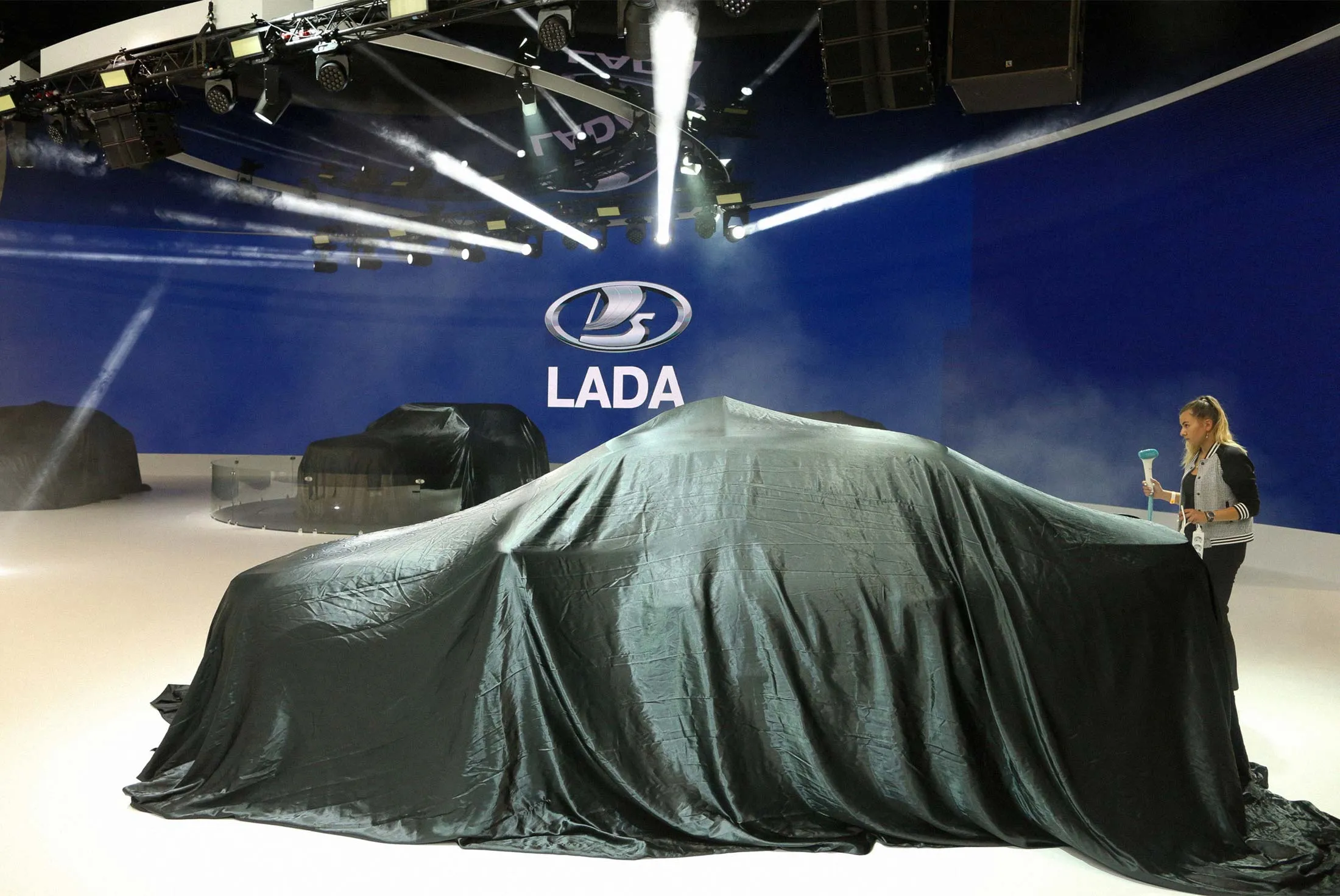 Cleaners prepare the stand before the unveiling of Lada’s latest automobiles at the Moscow International Auto Salon on Aug. 29, 2018.