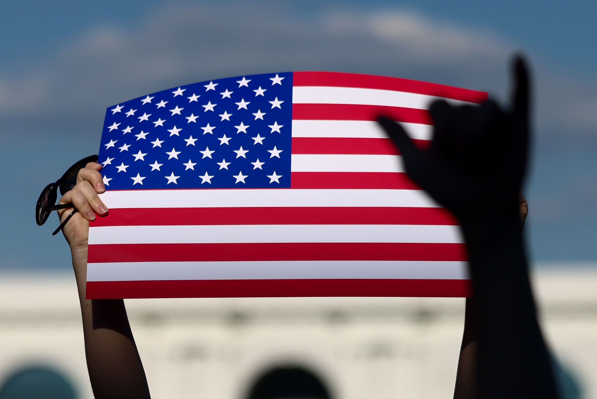 A person holds a US flag. 