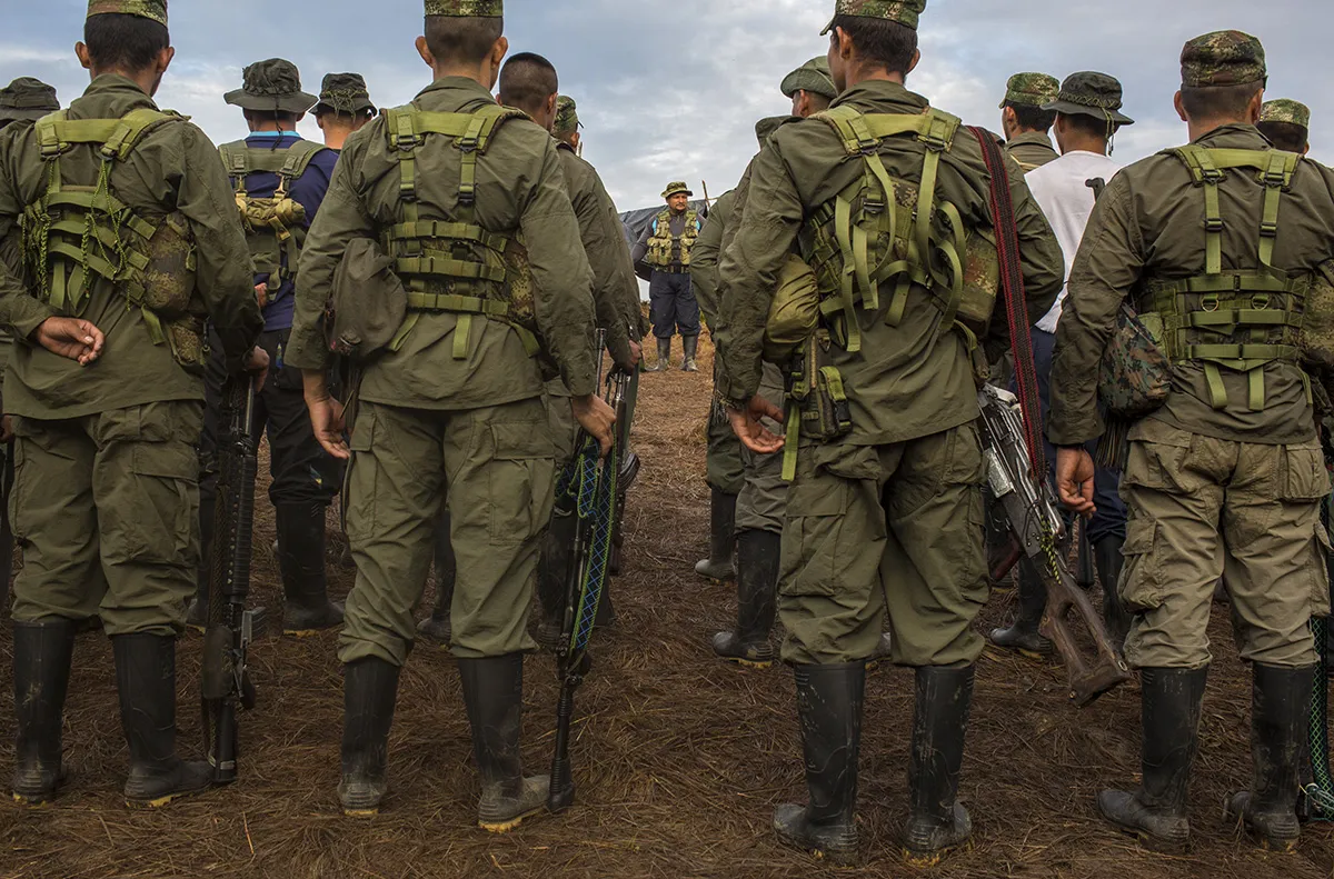 Revolutionary Armed Forces of Colombia rebels receive instructions for the day during FARC's 10th National Guerrilla conference in the Yari plains of El Diamante, Colombia, on Sept. 18, 2016.
