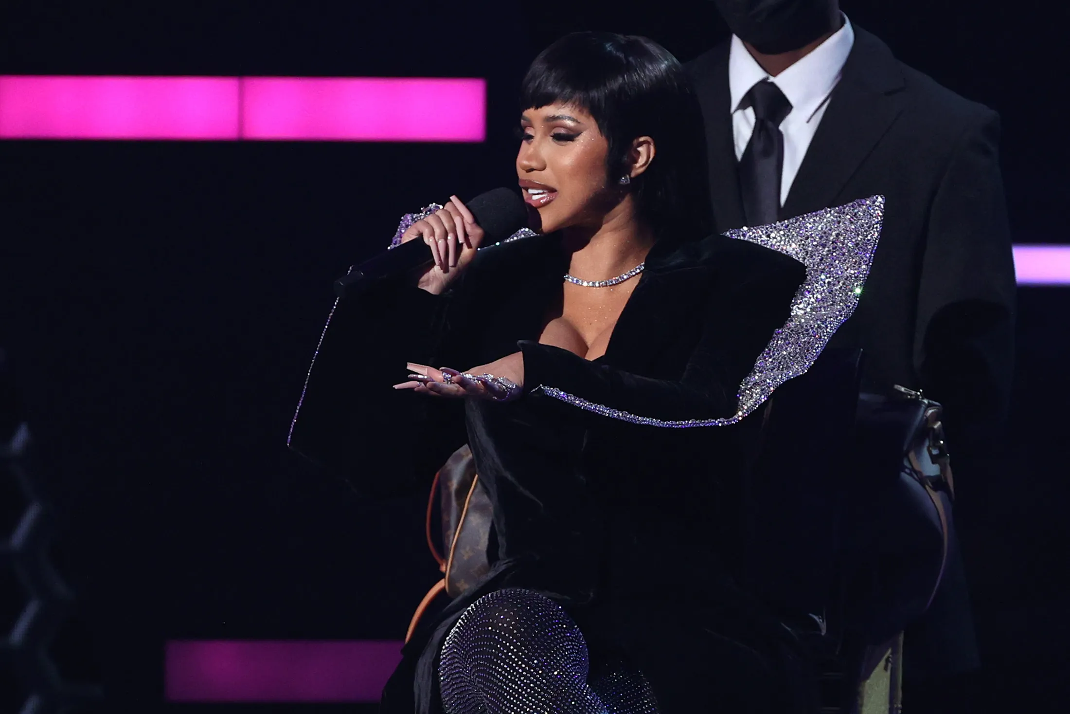 Cardi B speaks on stage during the American Music Awards in 2021.