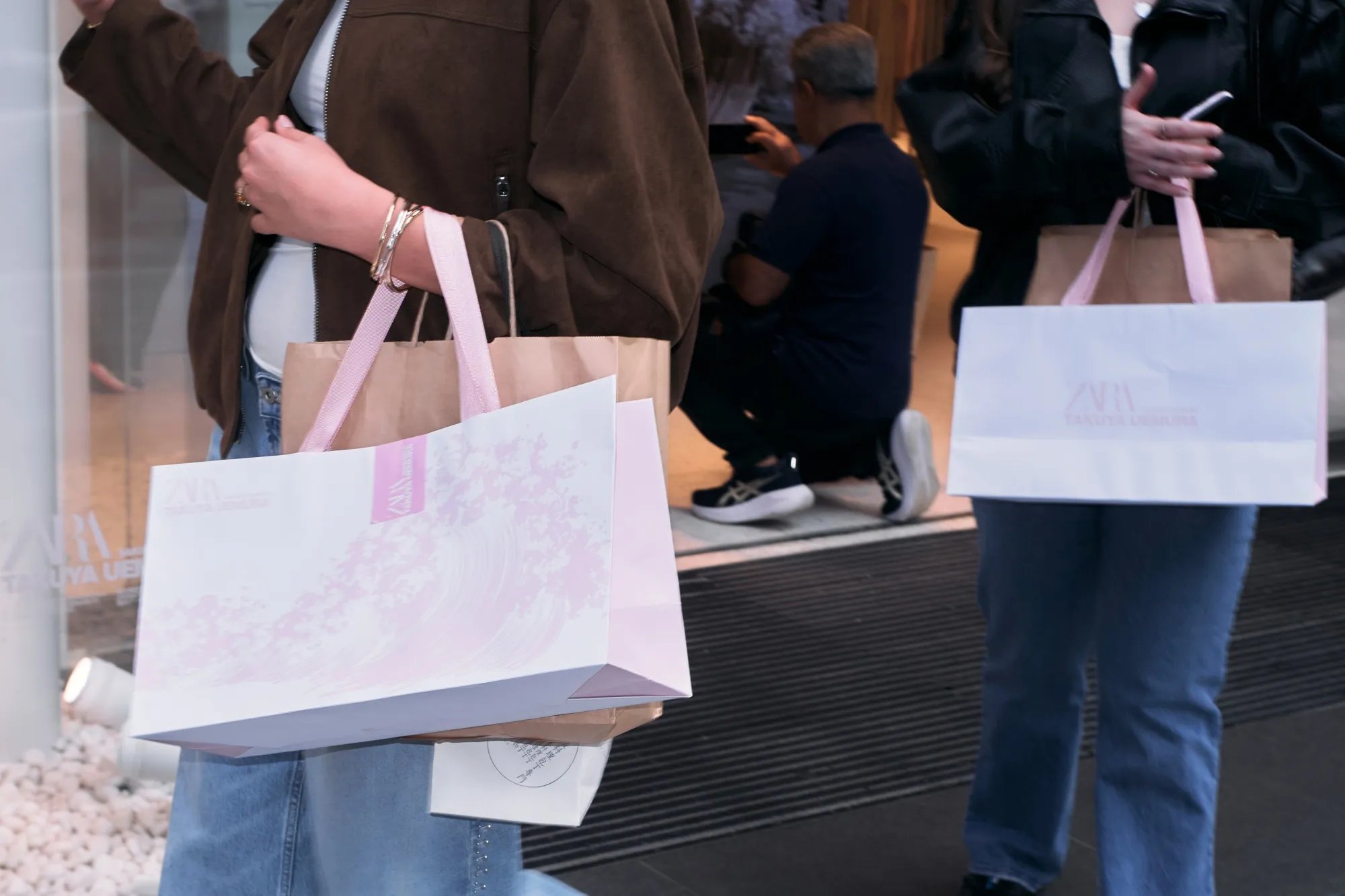 Shoppers carry a Zara bag in the Ginza district in Tokyo.