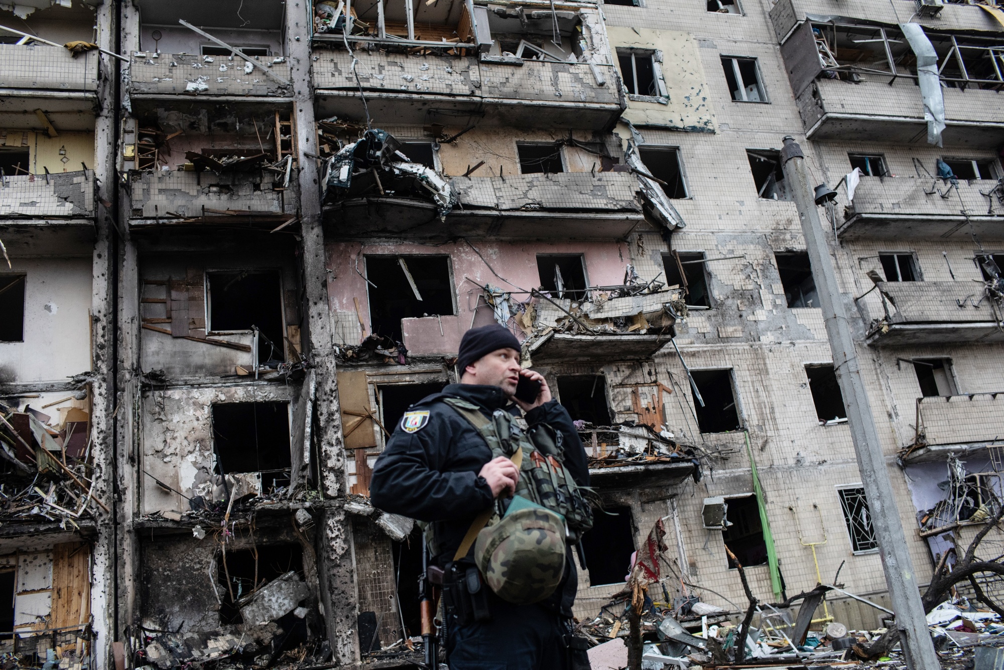 A policeman outside a residential building hit by Russian artillery strikes on Kyiv, Ukraine, on Feb. 25. Ukraine’s president said Kremlin forces were continuing attacks on military and civilian targets on the second day of their invasion.