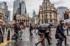 Londoners cross the street in front of the Bank of England in the City of London on Sept. 30, 2022.