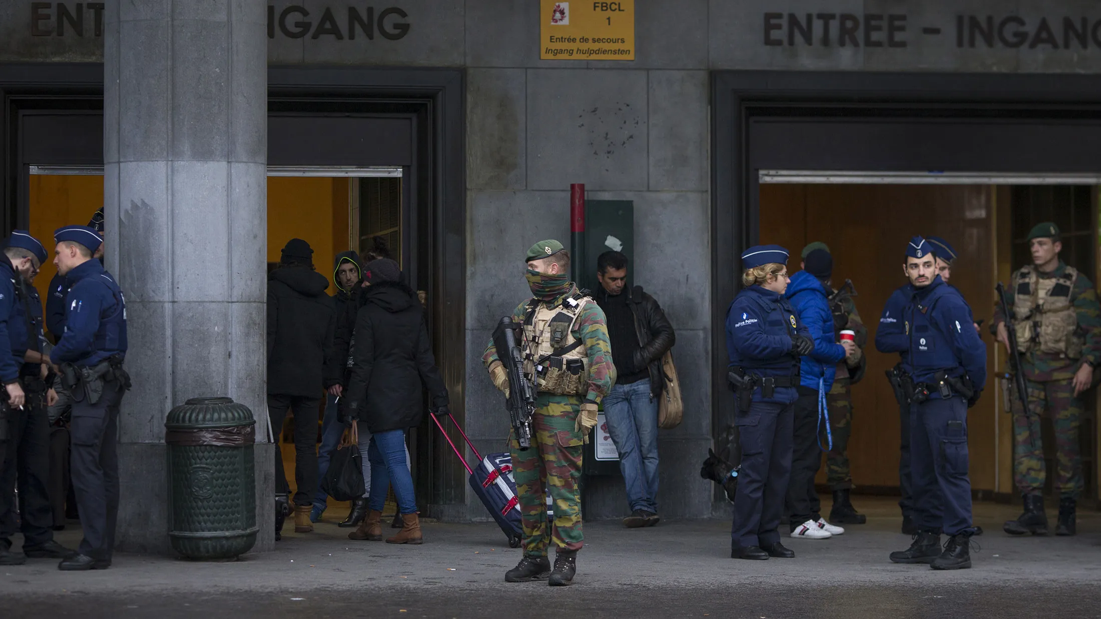 Police and soldiers stand guard outside Brussels central railway station in Belgium.
