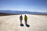 Visitors walk under the sun at Badwater Basin in Death Valley National Park. Photo by ETIENNE LAURENT/AFP via Getty Images) Photographer: ETIENNE LAURENT/AFP