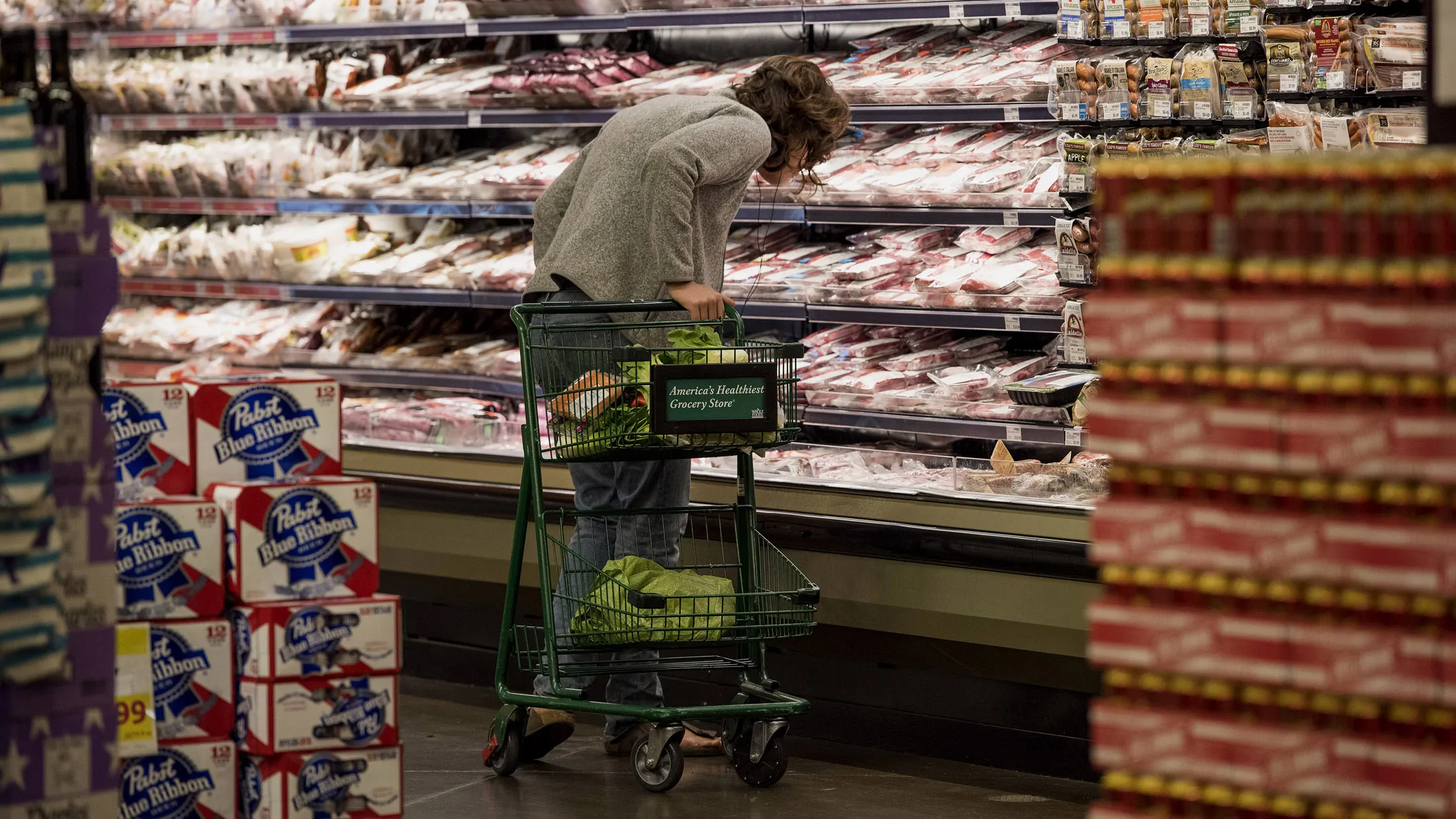 A customer shops at a Whole Foods Market store in Oakland, California.
