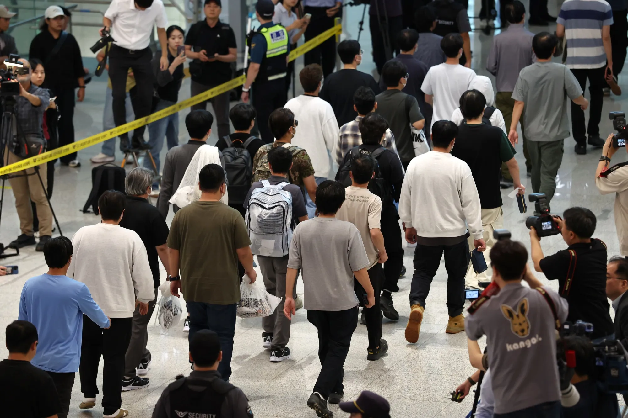 South Korean workers detained in the US immigration sweep arrive in Incheon, South Korea, on Sept. 12.