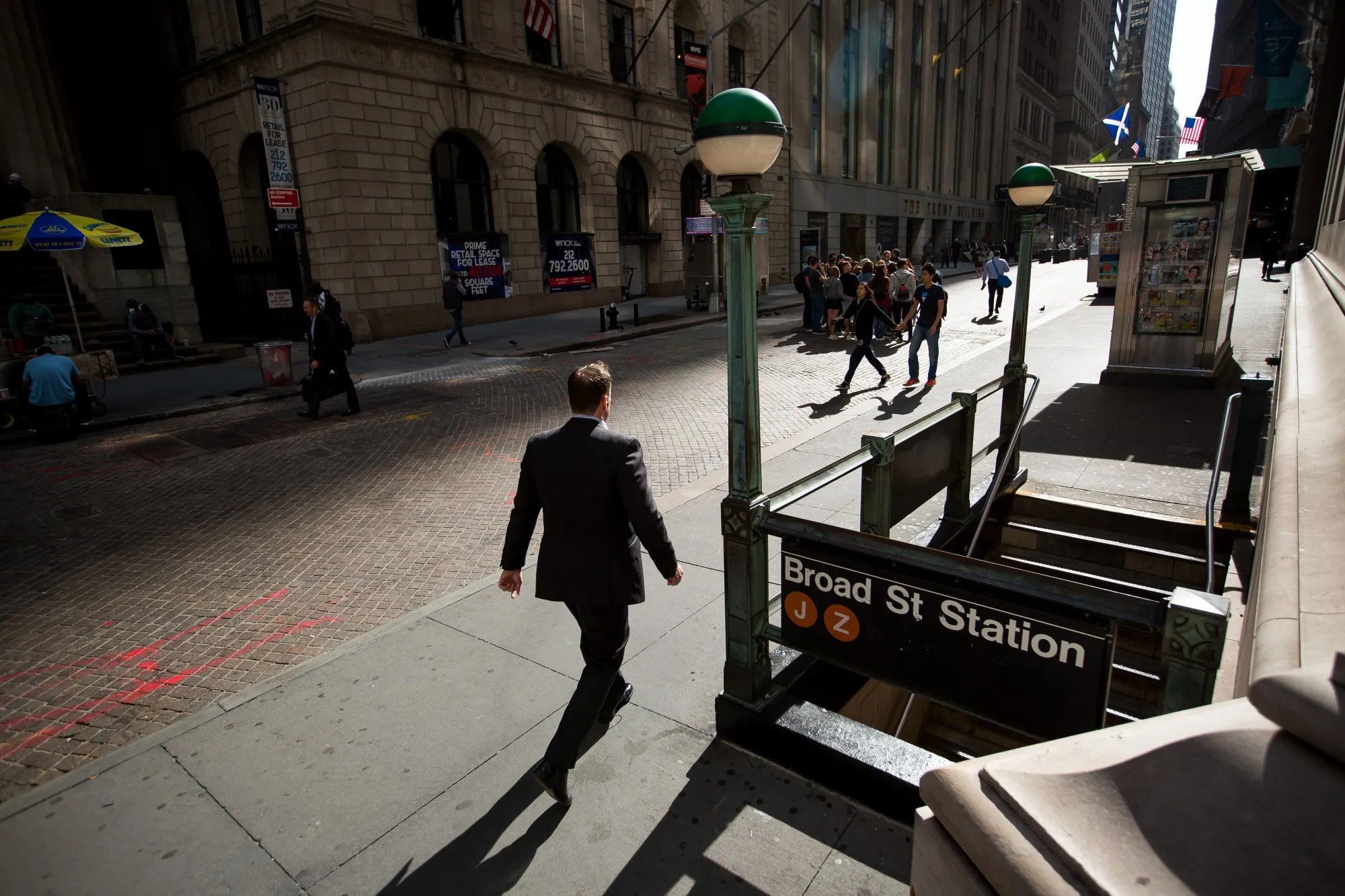 A pedestrian walks along Wall Street near the New York Stock Exchange.