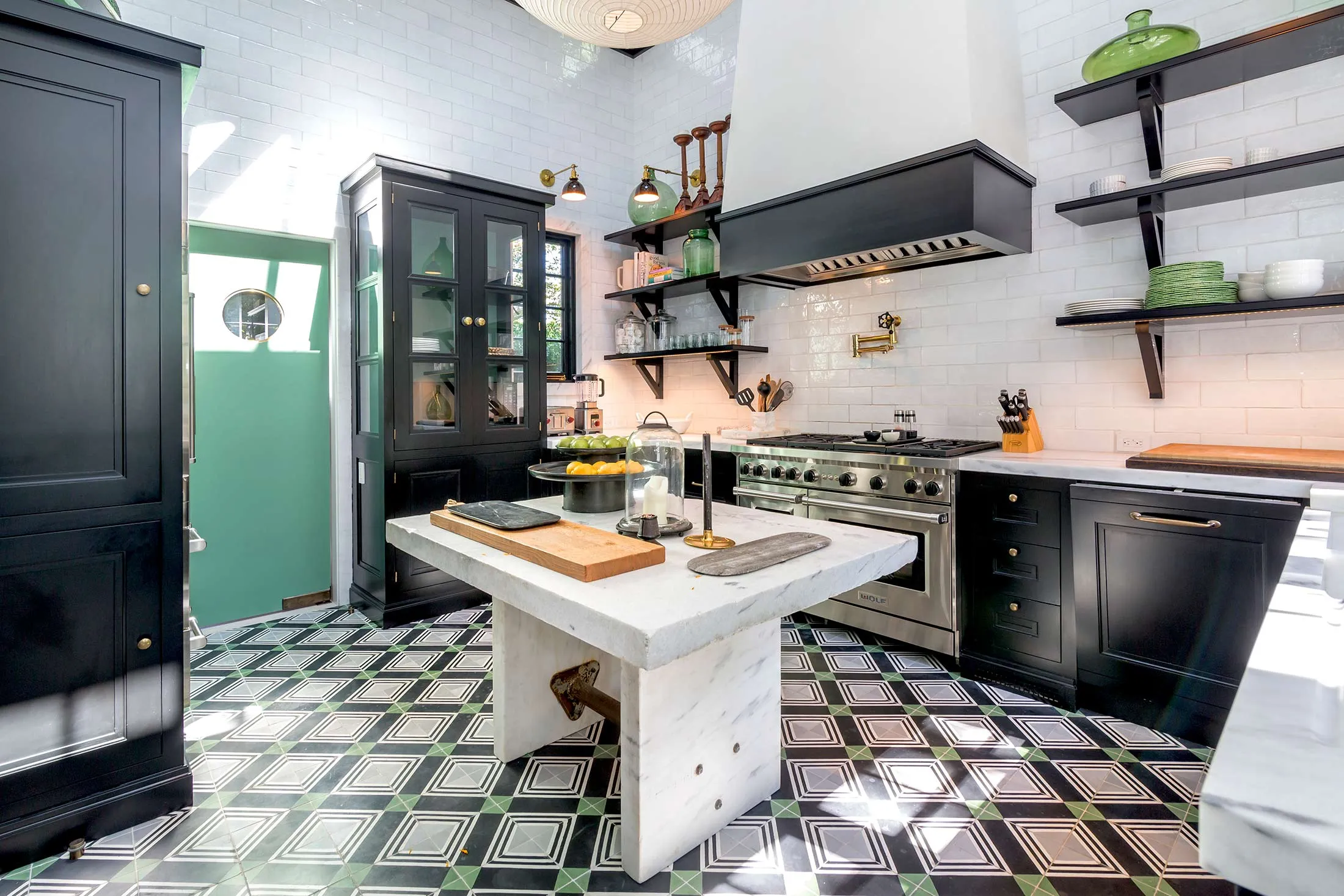 A restored kitchen in a $13.5 million house in Sag Harbor, N.Y., is lined with open shelving.