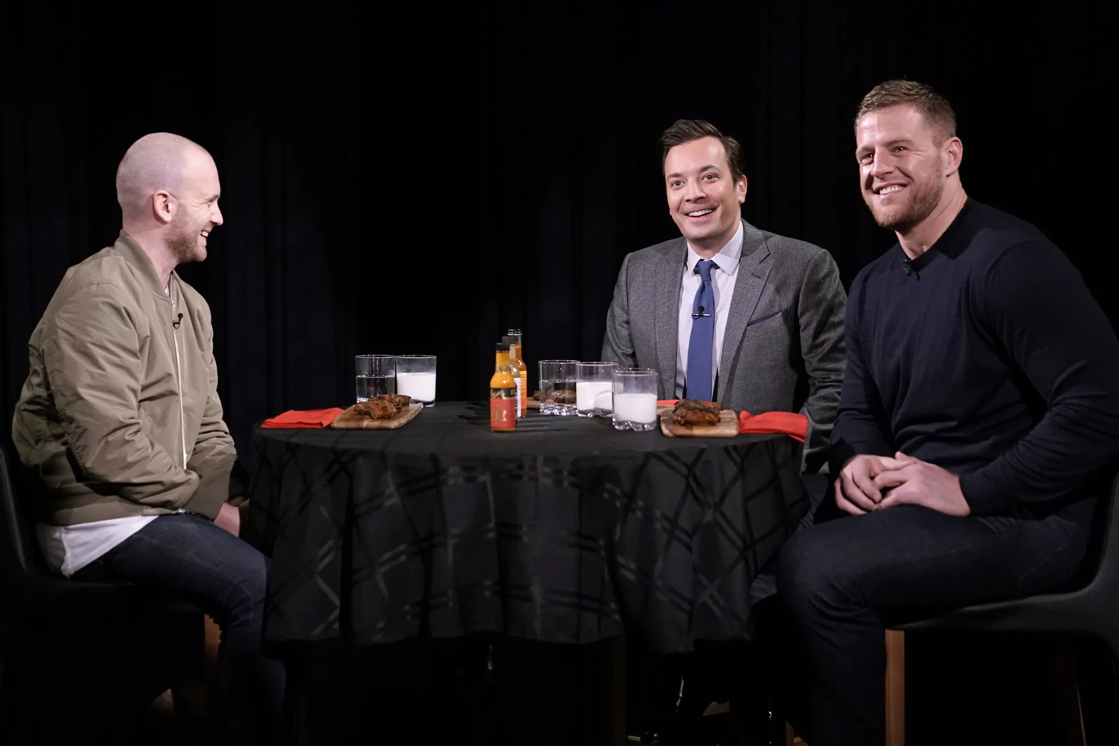 Sean Evans, from left, Jimmy Fallon and football player JJ Watt during “Hot Ones” on Jan. 30, 2020.