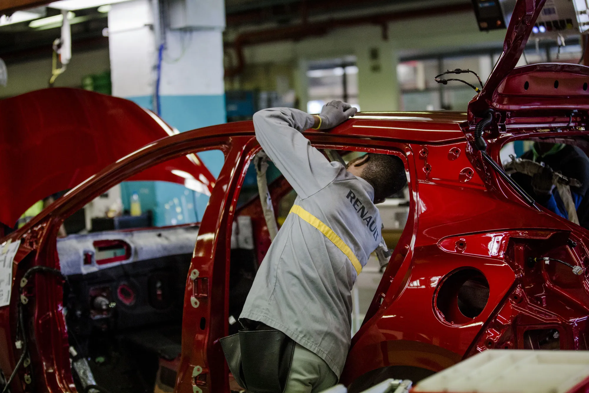 An employee carries out final inspections on the body shell of a freshly painted Nissan Micra automobile&nbsp;in Flins.