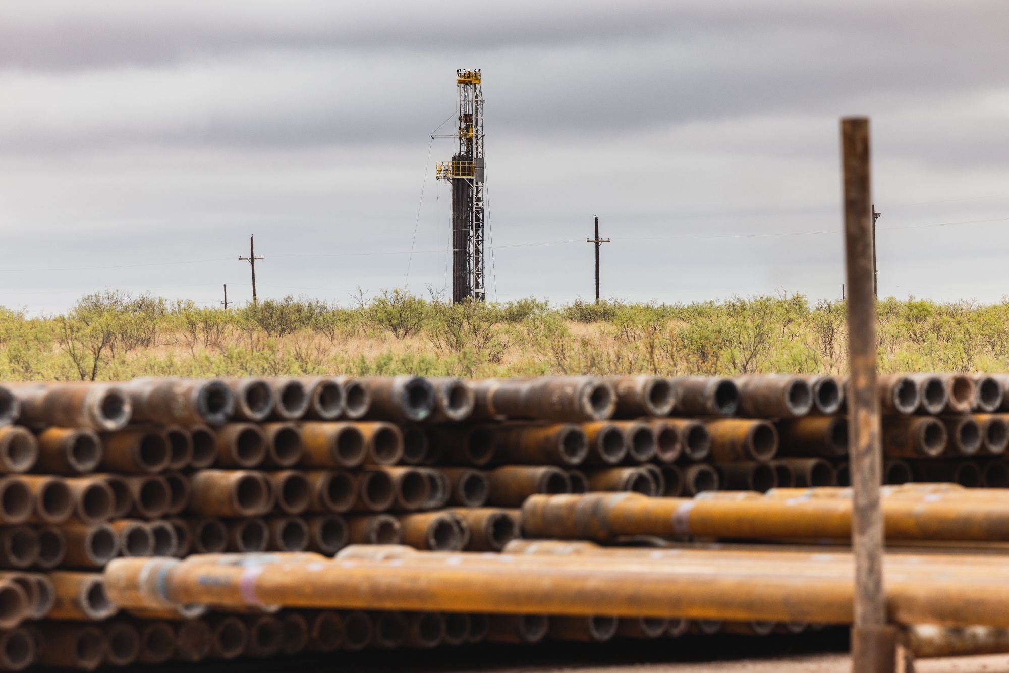 Stacks of steel pipes used for drilling oil wells at a drilling site on the land that the University of Texas System overseas in Andrews, Texas, US.
