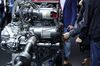 Attendees inspect a 4 cylinder diesel engine for a Mercedes-Benz B-Class automobile during the Daimler AG annual general meeting in Berlin, Germany, on Wednesday, May 22, 2019. Departing Daimler Chief Executive Officer Dieter Zetsche promised cost cuts and an efficiency drive to restore profit margins as the man who steered the Mercedes-Benz carmaker for more than a decade leaves his successor to tackle unprecedented industry upheaval.