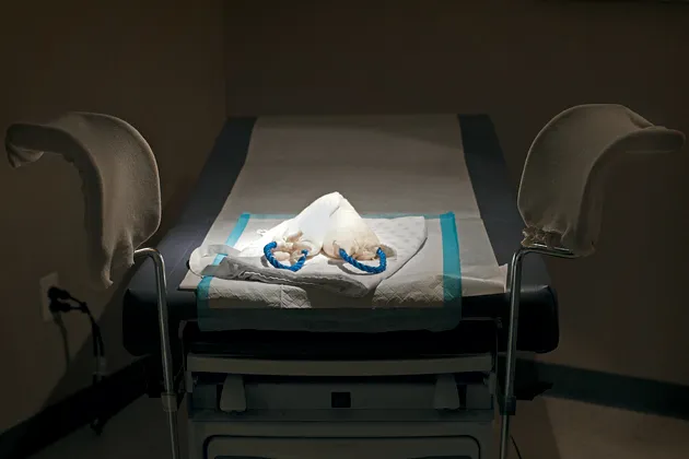 An exam room at Northland Family Planning’s office in Westland, Mich. On the bed are, from bottom: a protective mat made of paper and plastic, a patient’s robe, and a heating pad