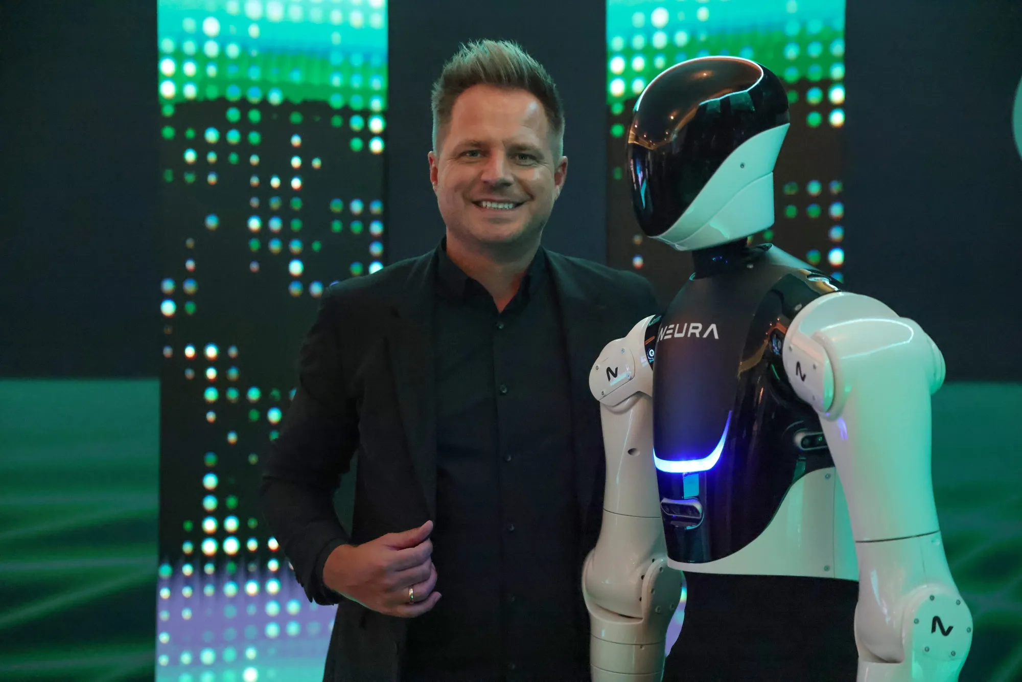 David Reger, chief executive officer of Neura Robotics, beside a Neura 4NE1 humanoid robot in October 2024 at the Bloomberg Tech Summit in London.