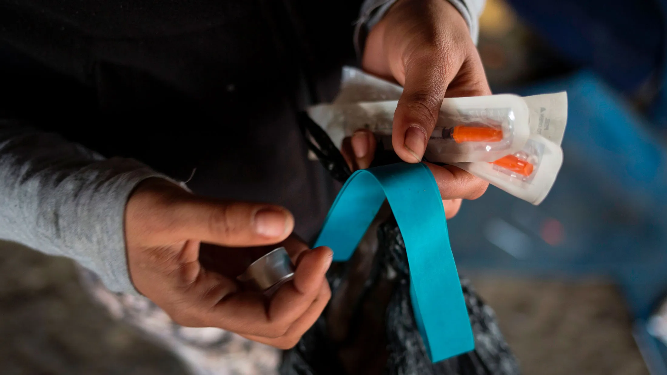 A homeless heroin addict shows her kit of clean needles, mixing cap and tourniquet in Philadelphia on April 14, 2017.
