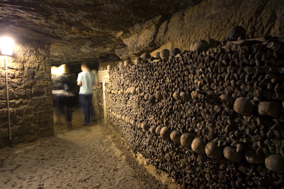 Human skulls and bones are stacked in a room in Paris's catacombs.