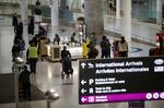 Travelers walk through Pearson airport in Toronto last month. Canada welcomed more than 400,000 immigrants in 2021.