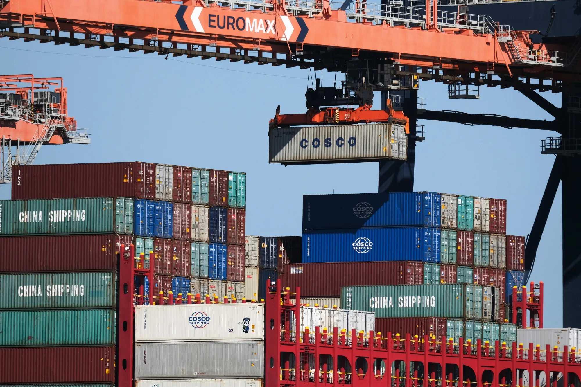 A crane lifts a shipping container from a cargo ship, operated by China Ocean Shipping Group Co. (COSCO), at the Euromax terminal at the Port of Rotterdam in Netherlands.