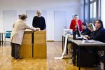 A voter casts her ballot at a polling station in Ascona, Switzerland, on Feb. 9