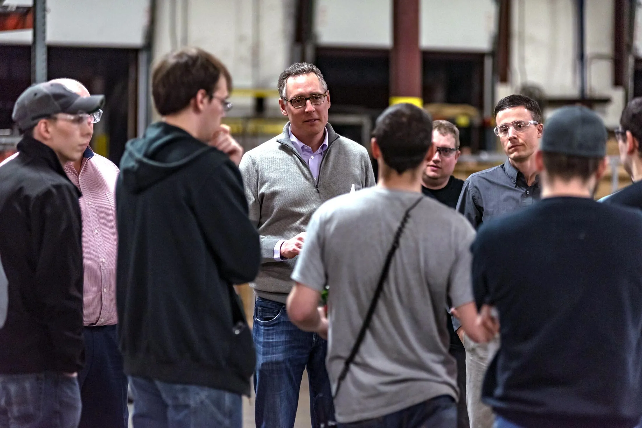 Stavros (center) speaking&nbsp;with employees of&nbsp;C.H.I. Overhead Doors in 2018.