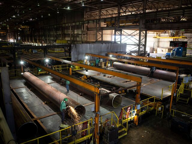 A steel worker grinds away rough surfaces on a high-grade steel pipe at JSW Steel Mill in Baytown, Texas on Thursday, February 6, 2020.