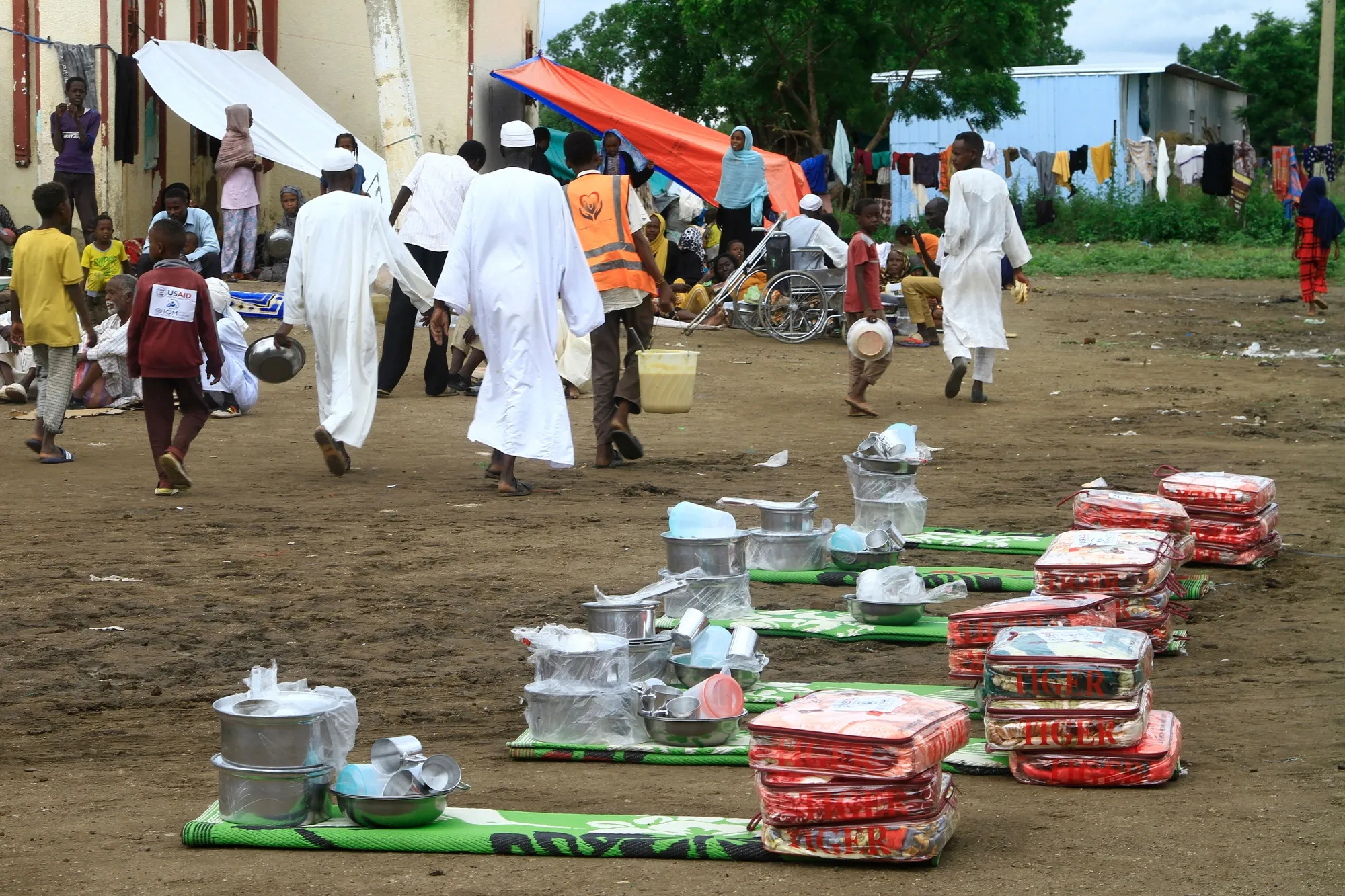 Displaced Sudanese receive humanitarian aid at their makeshift camp in Gedaref,&nbsp;on Aug. 22.