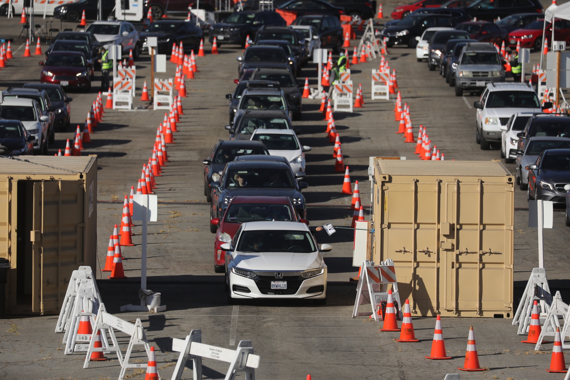 A driver receives a test kit at a Curative Inc. Covid-19 driving test site in the parking lot of Dodger Stadium in Los Angeles on November 13.