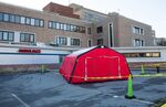 A medical tent to be used for drive-thru testing of Covid-19 is seen outside of the Carney Hospital in the Dorchester neighborhood of Boston.