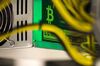 A bitcoin logo sits on a LL 1800W power unit supplying cryptocurrency mining machines at the SberBit mining \'hotel\' in Moscow, Russia, on Saturday, Dec. 9, 2017. Futures on the worlds most popular cryptocurrency surged as much as 26 percent in their debut session on Cboe Global Markets Inc.\'s exchange, triggering two temporary trading halts designed to calm the market.