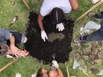 Uncovering a plot as part of a workshop with Community Miracles in Action in Cohoes, New York, in 2018.