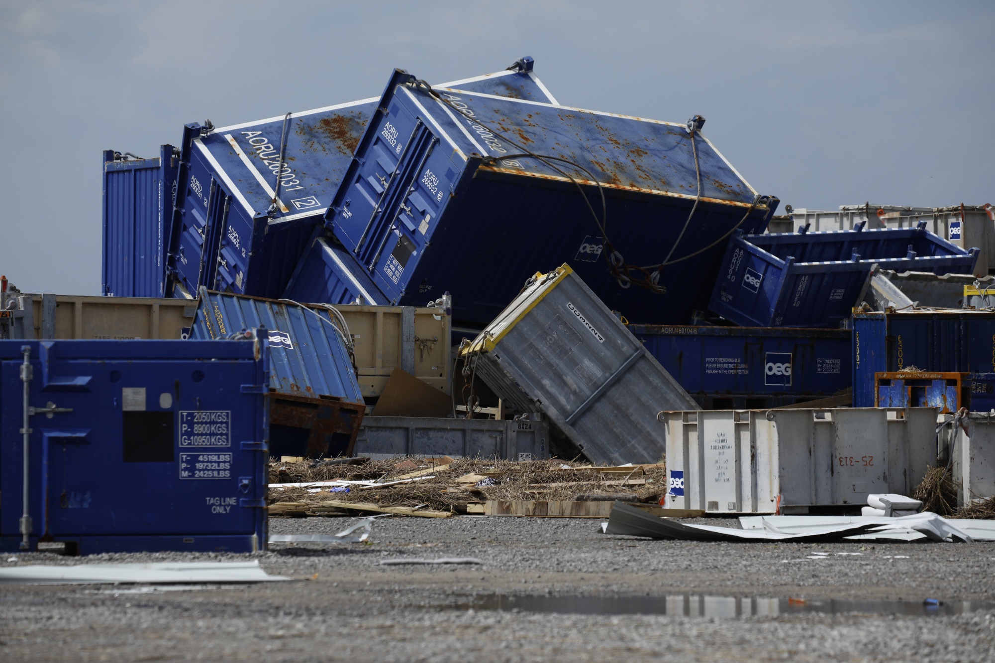 Offshore oil supply containers are strewn about after Hurricane Ida's storm surge swept through Port Fourchon, Louisiana.