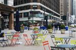 Chairs and tables sit empty in front of a Macy's Inc. store in the Midtown neighborhood of New York, U.S.