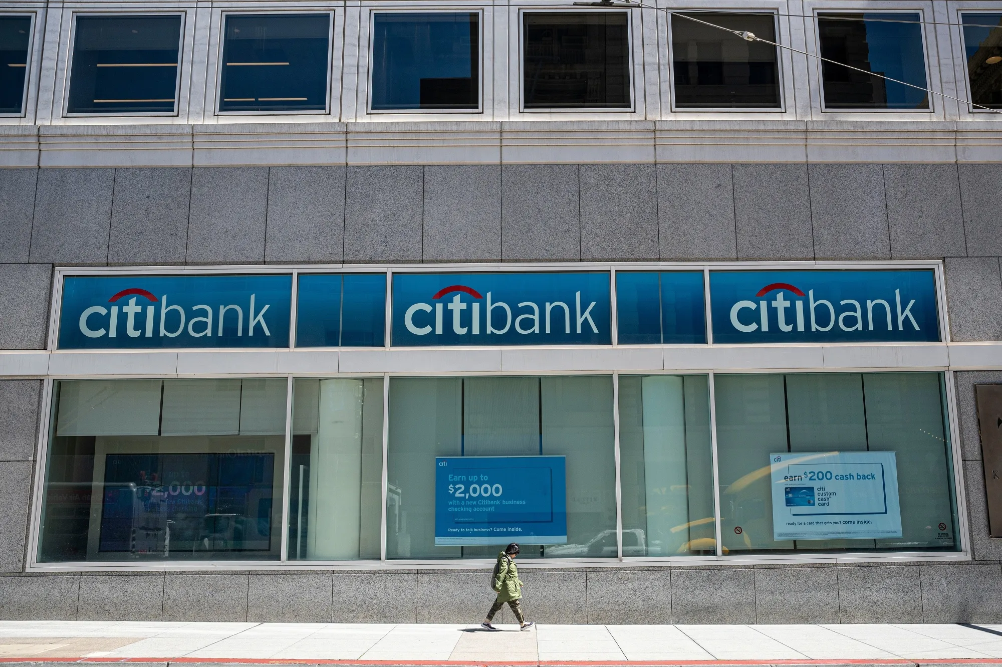 A pedestrian passes a Citibank branch in San Francisco.