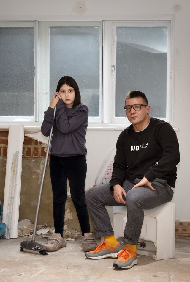 Willie Castro and his daugher in their flood damaged home. 