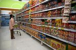 A customer looks at shelves of instant noodles at a supermarket in Bangkok.