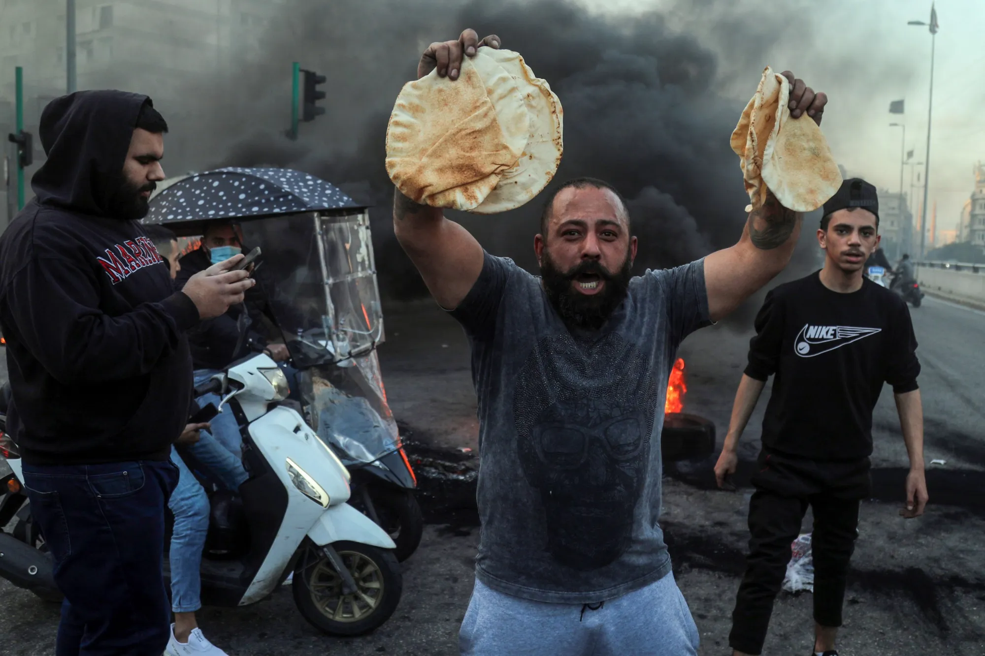 A demonstrator holds government subsidized bread during a protest in Beirut, on March 2.