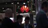 An illuminated logo hangs above the Huawei Technologies Co. pavilion on the opening day of the MWC Barcelona in Barcelona.